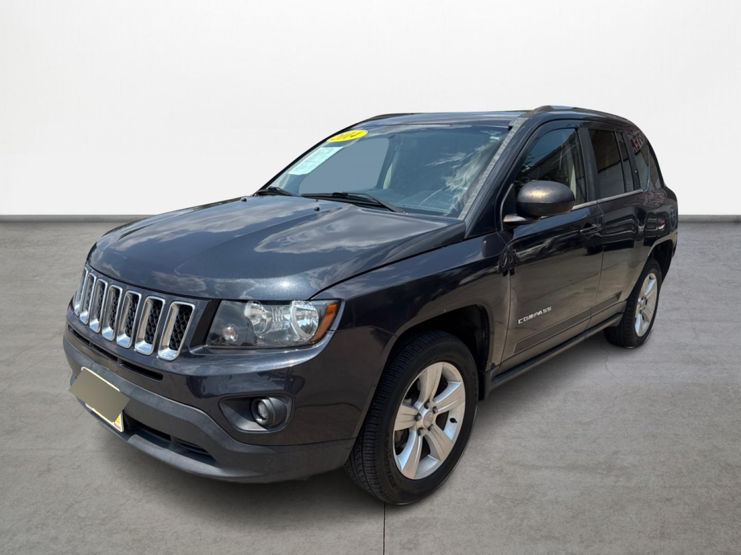 2014 Jeep Compass (1C4NJDBBXED) , located at 16710 Clay Rd., Houston, TX, 77084, (281) 859-7900, 29.834864, -95.656166 - Photo#0