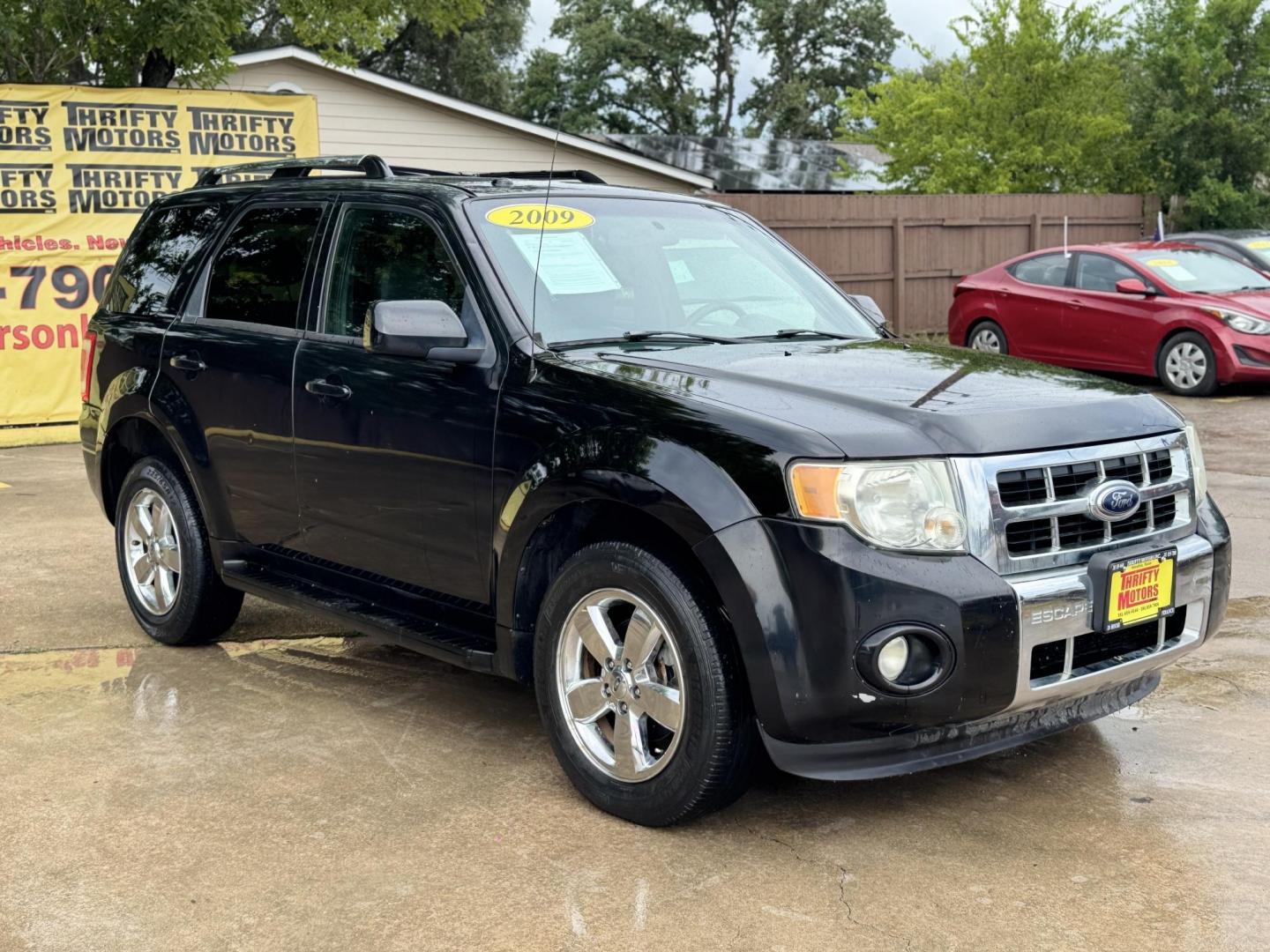 2009 Black /black Ford Escape Limited FWD V6 (1FMCU04GX9K) with an 3.0L V6 DOHC 24V engine, 4-Speed Automatic transmission, located at 16710 Clay Rd., Houston, TX, 77084, (281) 859-7900, 29.834864, -95.656166 - Photo#0
