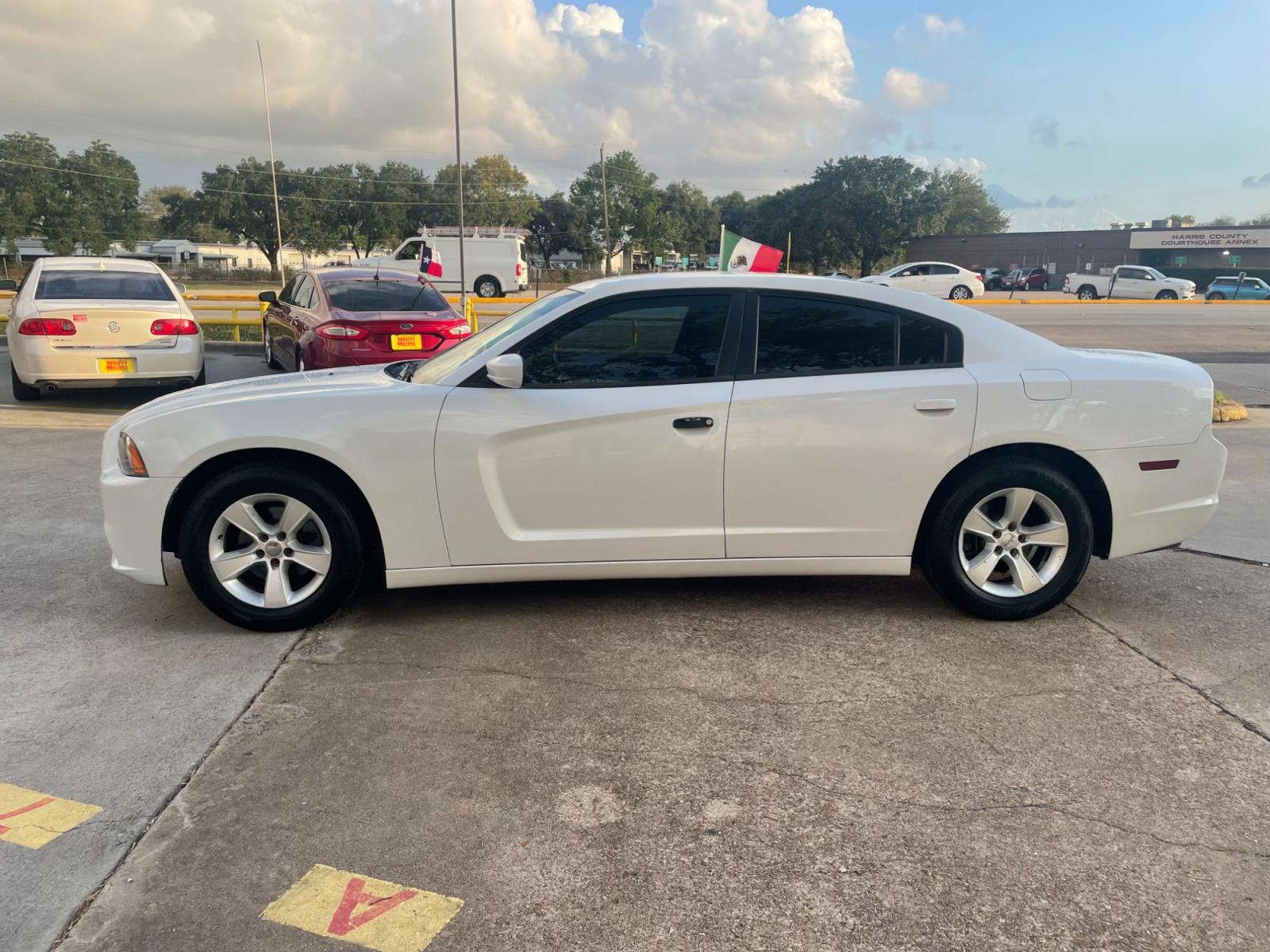 2014 White Dodge Charger SE (2C3CDXBG1EH) with an 3.6L V6 DOHC 24V engine, 5-Speed Automatic transmission, located at 16710 Clay Rd., Houston, TX, 77084, (281) 859-7900, 29.834864, -95.656166 - Photo #0