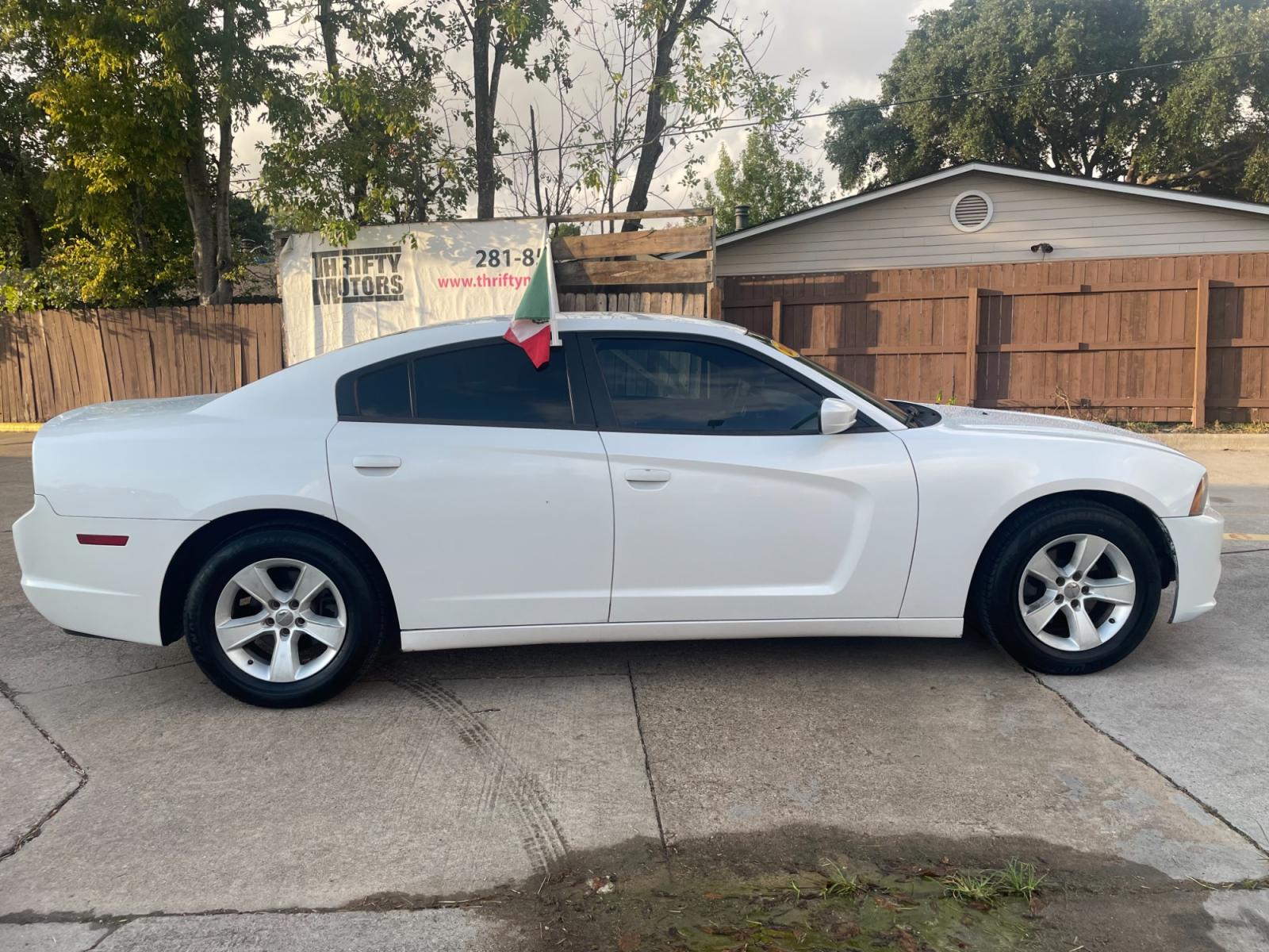 2014 White Dodge Charger SE (2C3CDXBG1EH) with an 3.6L V6 DOHC 24V engine, 5-Speed Automatic transmission, located at 16710 Clay Rd., Houston, TX, 77084, (281) 859-7900, 29.834864, -95.656166 - Photo #1