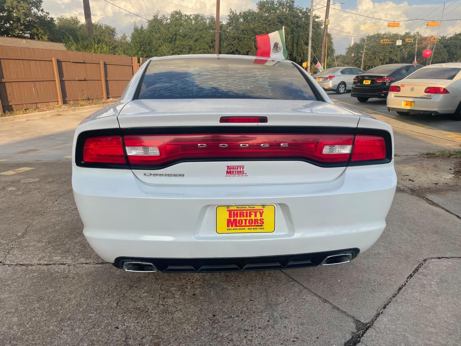 2014 White Dodge Charger SE (2C3CDXBG1EH) with an 3.6L V6 DOHC 24V engine, 5-Speed Automatic transmission, located at 16710 Clay Rd., Houston, TX, 77084, (281) 859-7900, 29.834864, -95.656166 - Photo #2