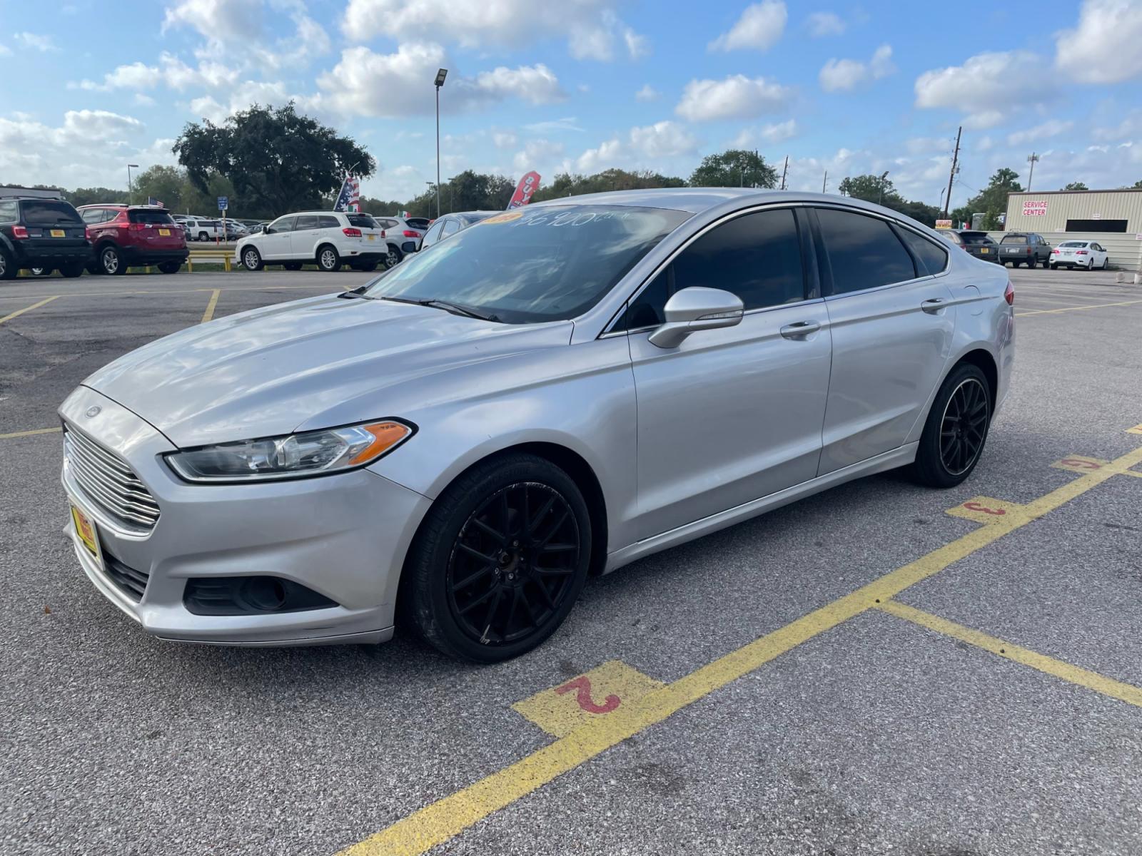 2015 Silver Ford Fusion SE (3FA6P0H94FR) with an 2.0L L4 DOHC 16V engine, located at 16710 Clay Rd., Houston, TX, 77084, (281) 859-7900, 29.834864, -95.656166 - Photo #0