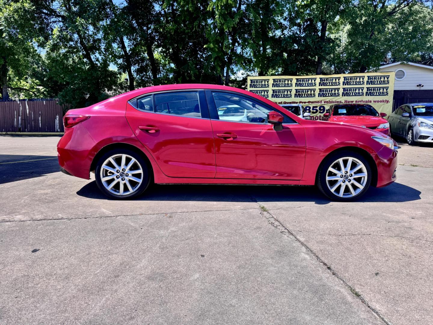 2017 Red /Black Mazda MAZDA3 i Touring AT 4-Door (JM1BN1V76H1) with an 2.0L L4 DOHC 16V engine, Automatic 6-Speed transmission, located at 16710 Clay Rd., Houston, TX, 77084, (281) 859-7900, 29.834864, -95.656166 - Low Dow. Low Payments. - Photo#1