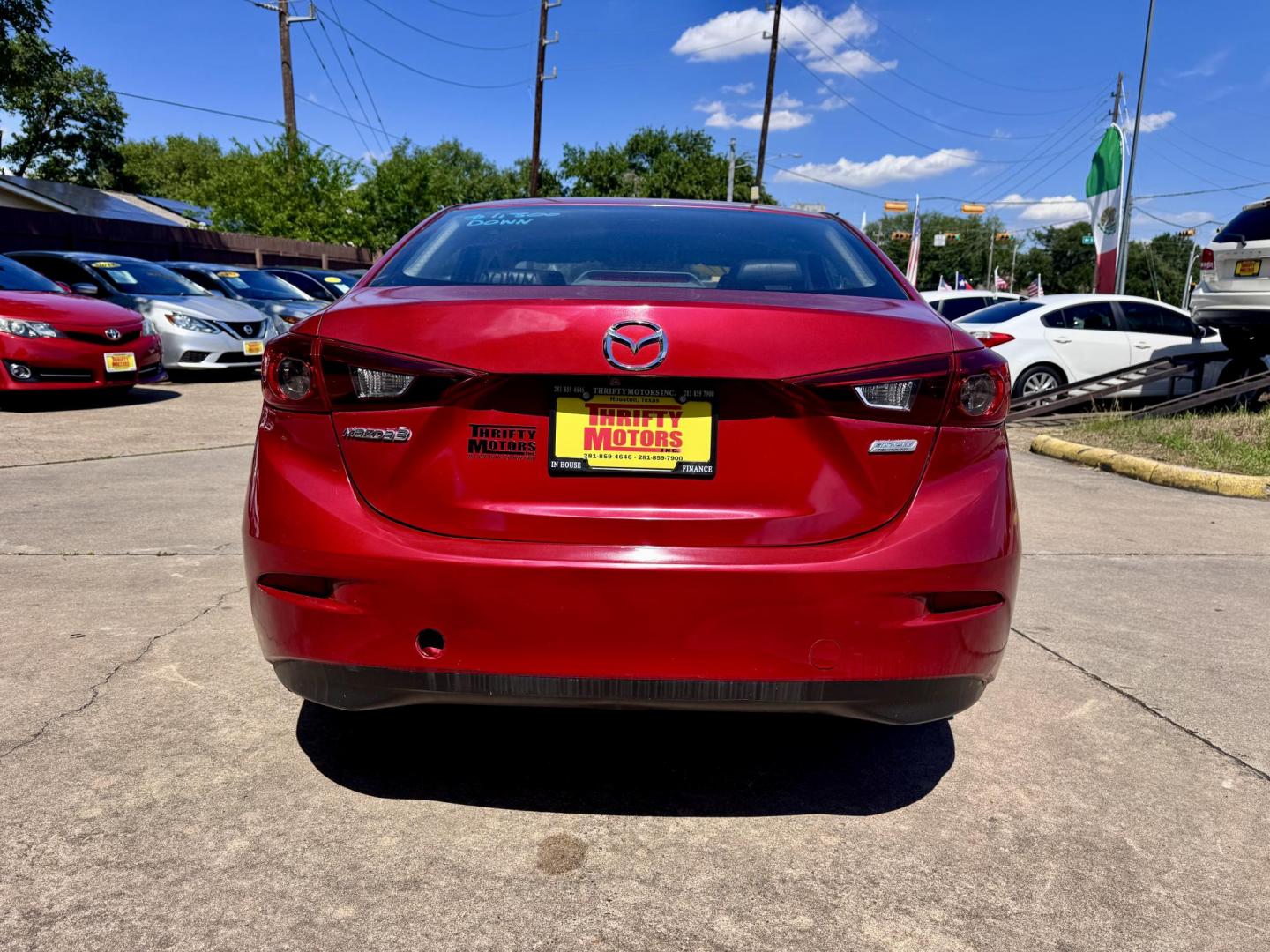 2017 Red /Black Mazda MAZDA3 i Touring AT 4-Door (JM1BN1V76H1) with an 2.0L L4 DOHC 16V engine, Automatic 6-Speed transmission, located at 16710 Clay Rd., Houston, TX, 77084, (281) 859-7900, 29.834864, -95.656166 - Low Dow. Low Payments. - Photo#3
