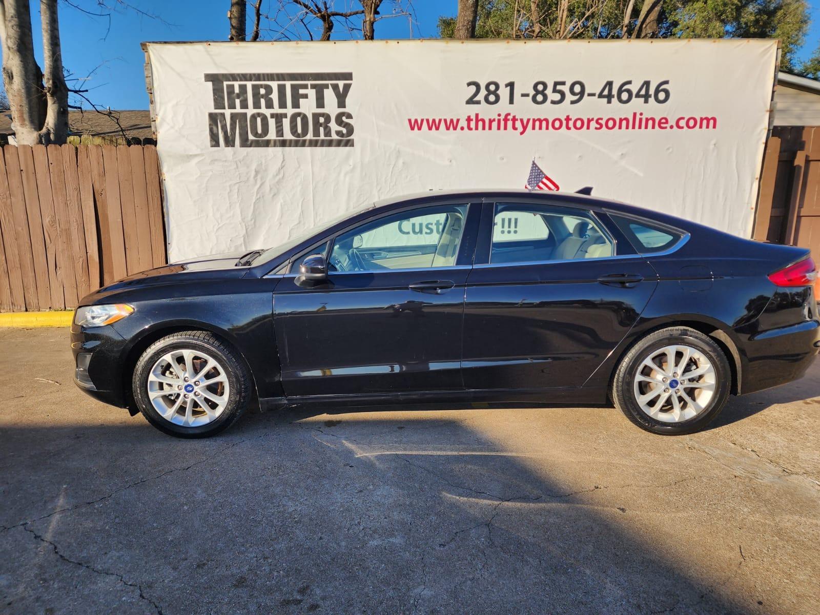 2019 Black Ford Fusion SE (3FA6P0H77KR) with an 2.5L L4 DOHC 16V engine, 6A transmission, located at 16710 Clay Rd., Houston, TX, 77084, (281) 859-7900, 29.834864, -95.656166 - Photo #0