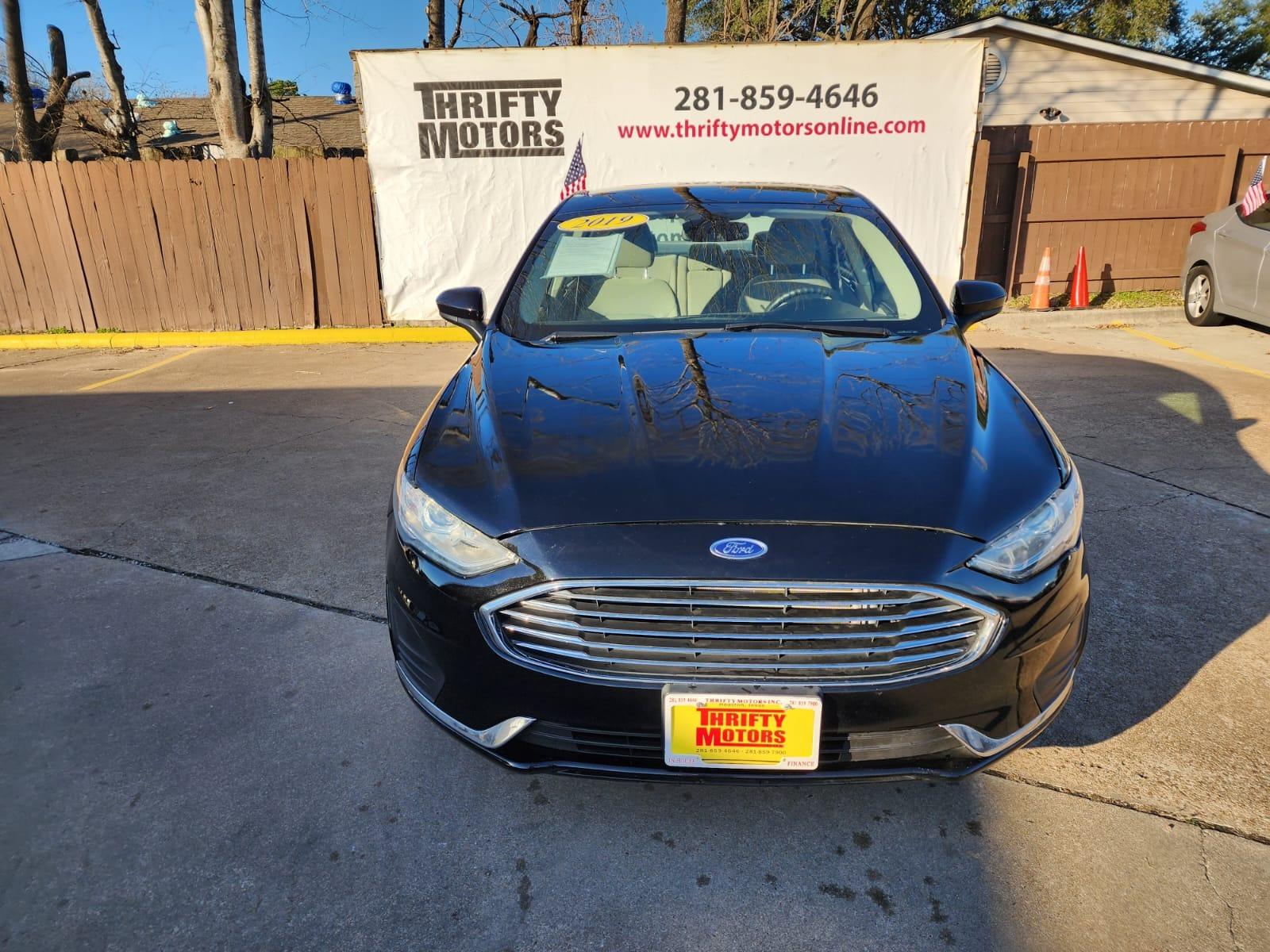 2019 Black Ford Fusion SE (3FA6P0H77KR) with an 2.5L L4 DOHC 16V engine, 6A transmission, located at 16710 Clay Rd., Houston, TX, 77084, (281) 859-7900, 29.834864, -95.656166 - Low Down. Low Payments. - Photo #1