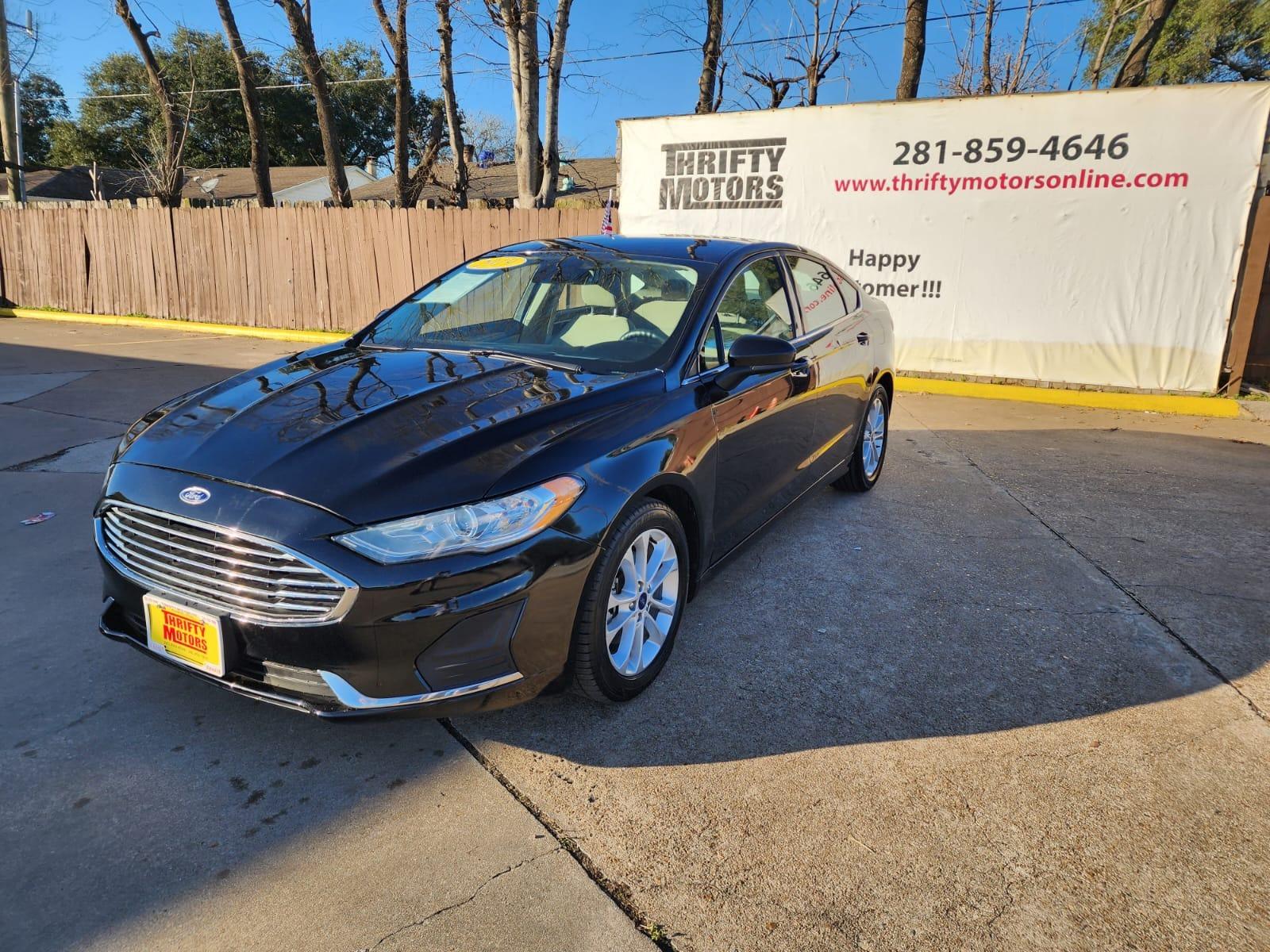 2019 Black Ford Fusion SE (3FA6P0H77KR) with an 2.5L L4 DOHC 16V engine, 6A transmission, located at 16710 Clay Rd., Houston, TX, 77084, (281) 859-7900, 29.834864, -95.656166 - Photo #2