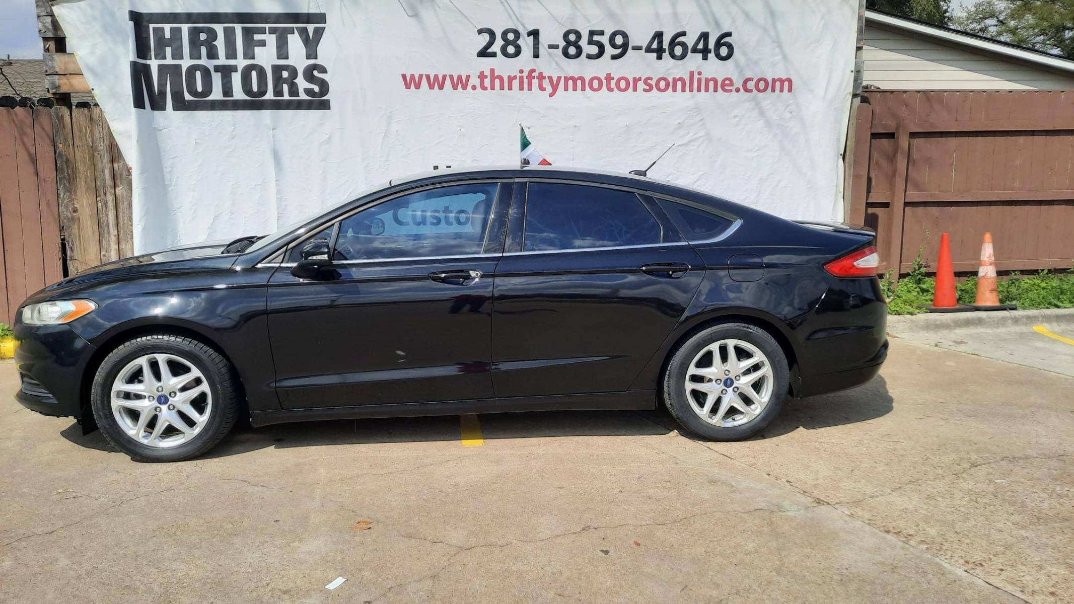 2013 Black Ford Fusion SE (3FA6P0HR7DR) with an 1.6L L4 DOHC 16V engine, located at 16710 Clay Rd., Houston, TX, 77084, (281) 859-7900, 29.834864, -95.656166 - Photo #0