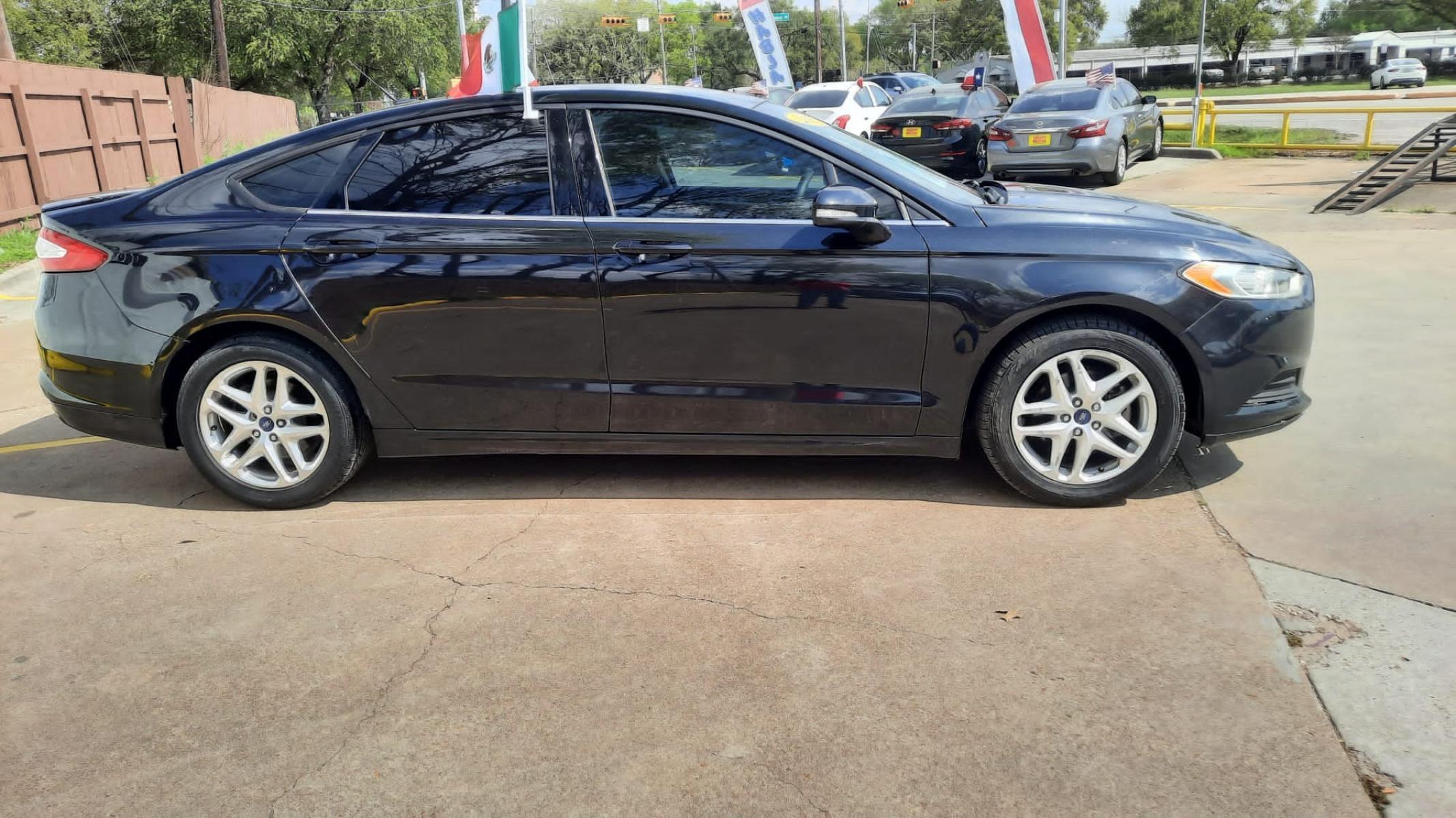 2013 Black Ford Fusion SE (3FA6P0HR7DR) with an 1.6L L4 DOHC 16V engine, located at 16710 Clay Rd., Houston, TX, 77084, (281) 859-7900, 29.834864, -95.656166 - LOW DOWN. LOW PAYMENTS. - Photo #1